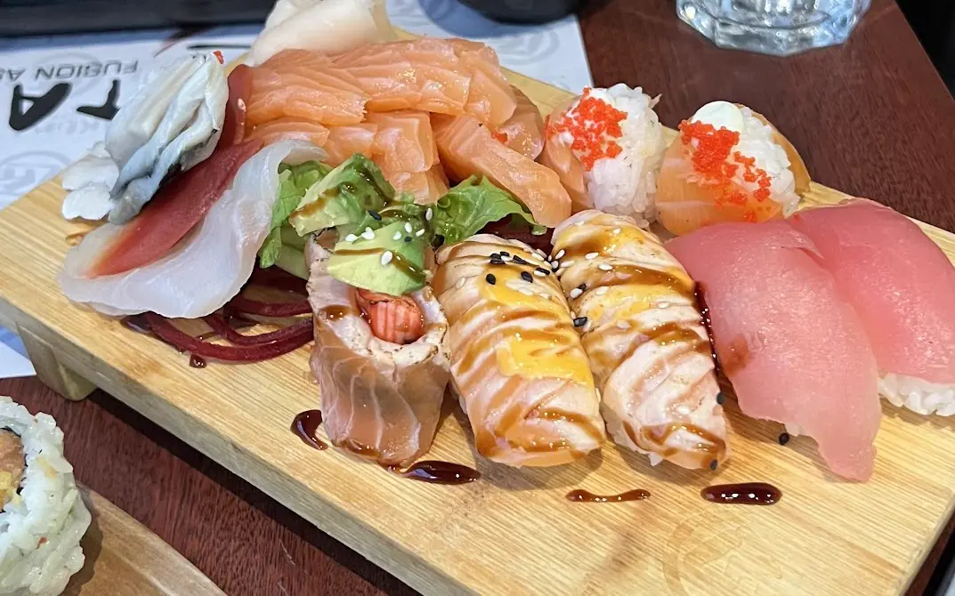 A massive sushi platter on a dark restaurant table